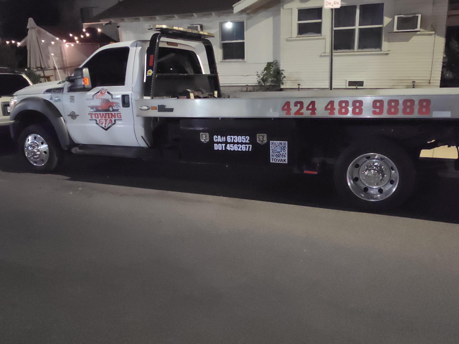 Towing GTA tow truck parked on a residential street at night